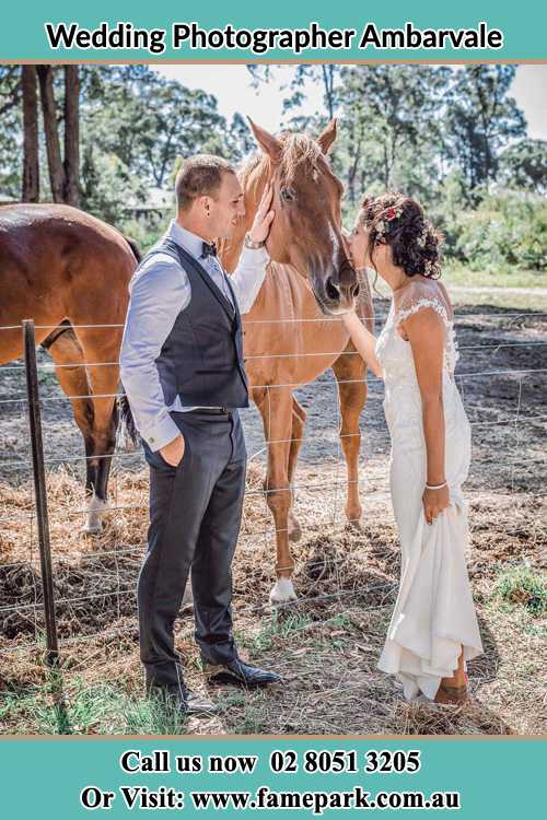 Photo of the Groom and the Bride caressing a horse Ambarvale NSW 2560