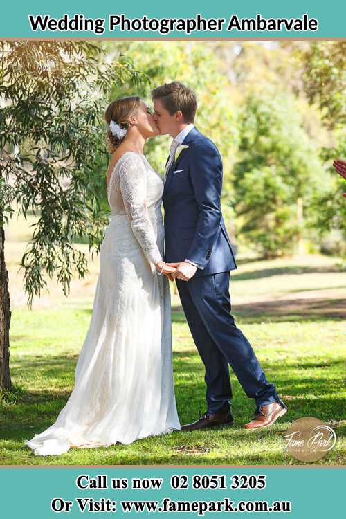 Photo of the Bride and the Groom kissing at the yard Ambarvale NSW 2560