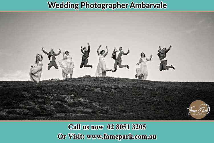 Jump shot photo of the Groom and the Bride with the entourage Ambarvale NSW 2560