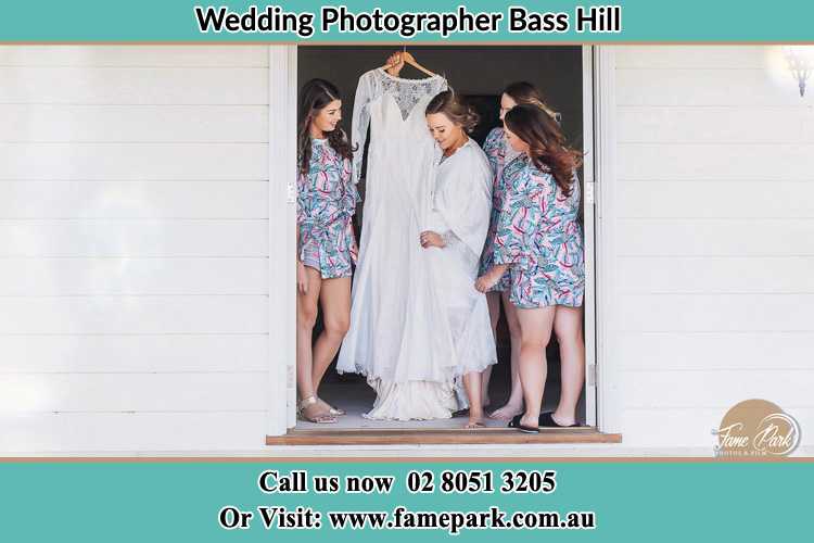 Photo of the Bride and the bridesmaids checking the wedding gown at the door Bass Hill NSW 2197