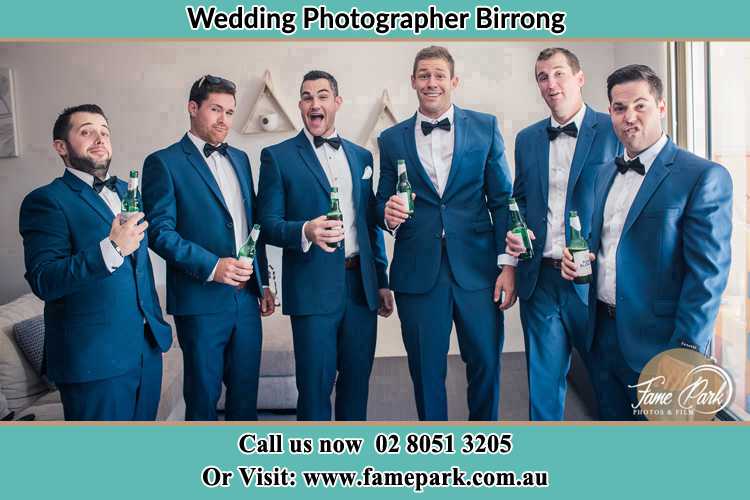 The groom and his groomsmen striking a wacky pose in front of the camera Birrong NSW 2143