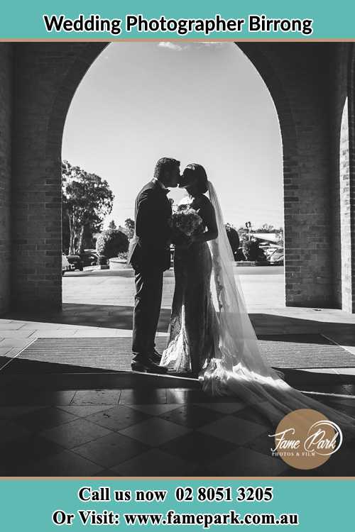 Photo of the Groom and the Bride kissing at the front of the church Birrong NSW 2143