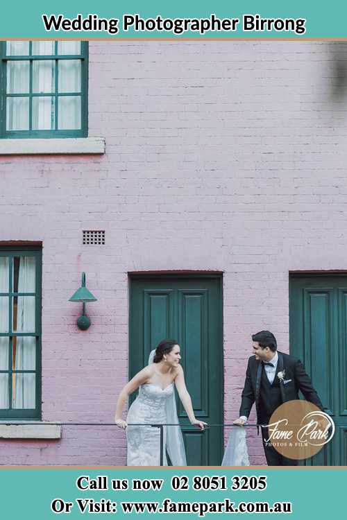 Photo of the Bride and the Groom looking each other at the balcony Birrong NSW 2143