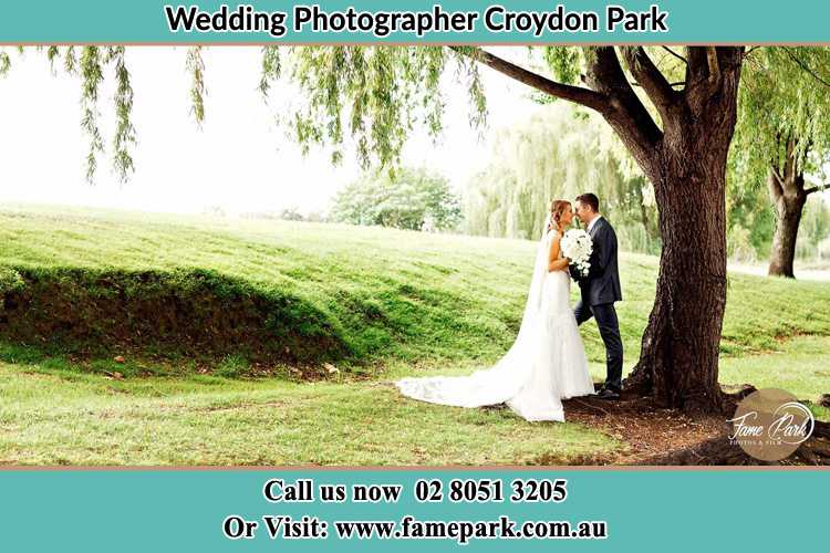 Photo of the Bride and the Groom kissing under the tree Croydon Park NSW 2133