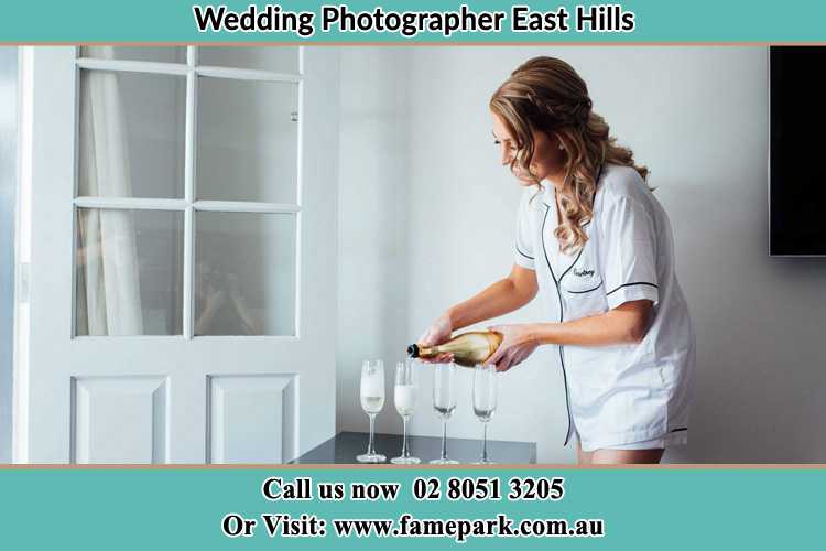 Photo of the Bride pouring wine on the glasses East Hills NSW 2213