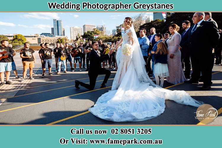 Groom Kneeling down in front of the Bride Greystanes NSW 2145