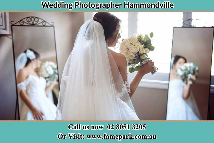 Photo of the Bride holding flower at the front of the mirrors Hammondville NSW 2170