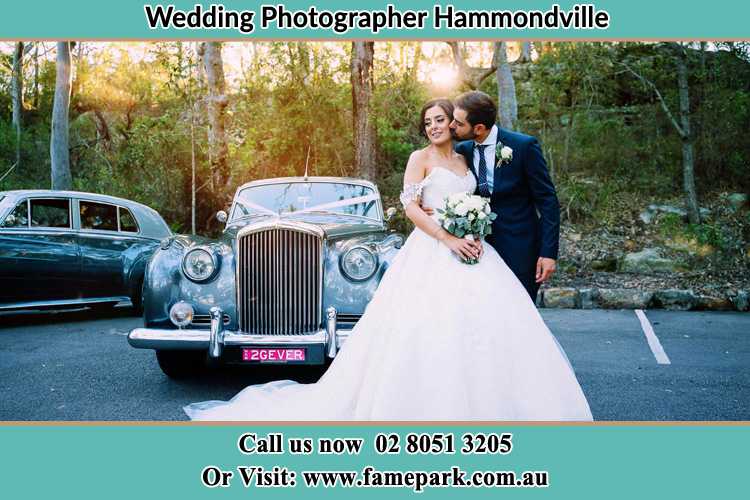 Photo of the Bride and the Groom at the front of the bridal car Hammondville NSW 2170