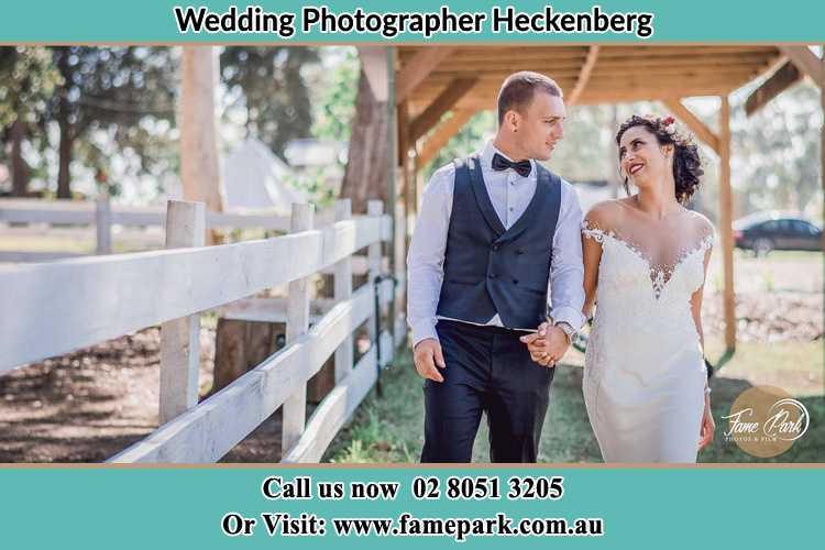 Photo of the Groom and the Bride holding hands while walking Heckenberg NSW 2168