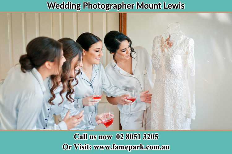 Photo of the Bride and the bridesmaids looking at the wedding gown Mount Lewis NSW 2190