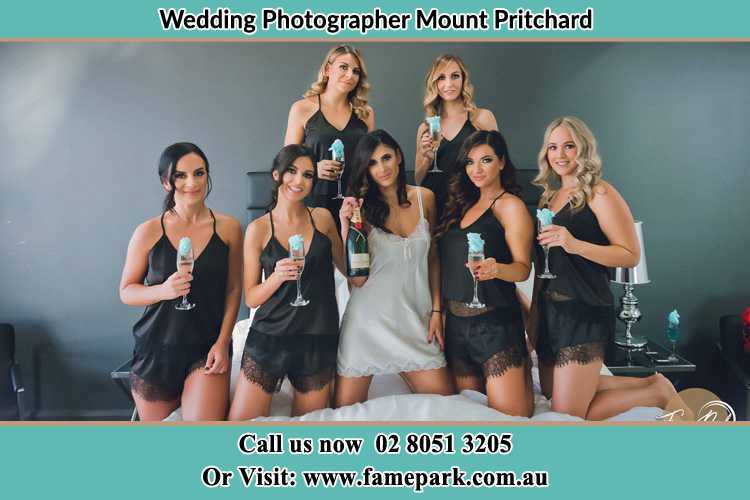 Photo of the Bride and the bridesmaids wearing lingerie and holding glass of wine on bed Mount Pritchard NSW 2170