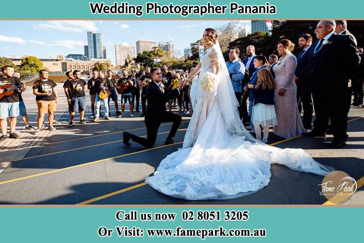 Groom Kneeling down in front of the Bride Panania NSW 2213