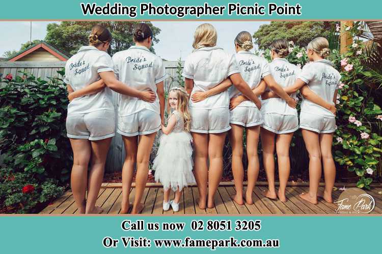 Behind photo of the Bride and the bridesmaids with the flower girl looking back Picnic Point NSW 2213