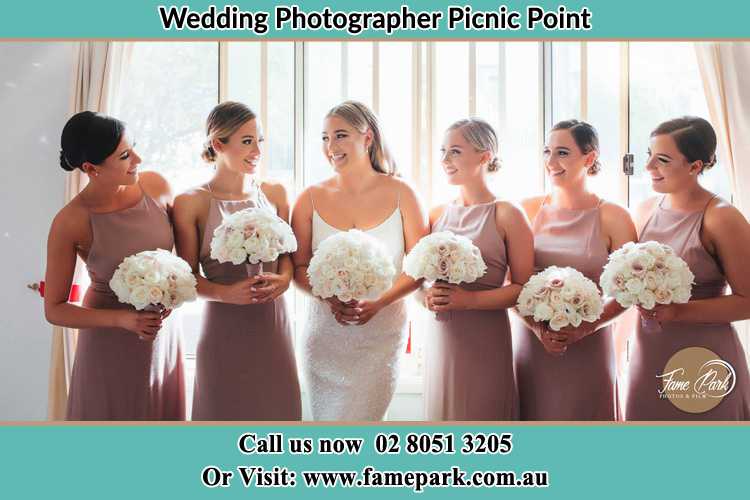 Photo of the Bride and the bridesmaids holding flower bouquet Picnic Point NSW 2213