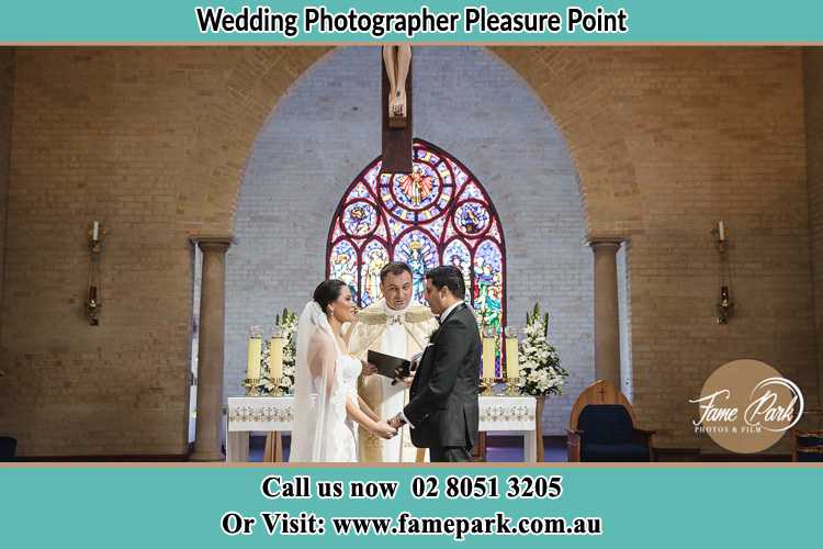 Photo of the Bride and Groom at the Altar with the Priest Pleasure Point NSW 2172