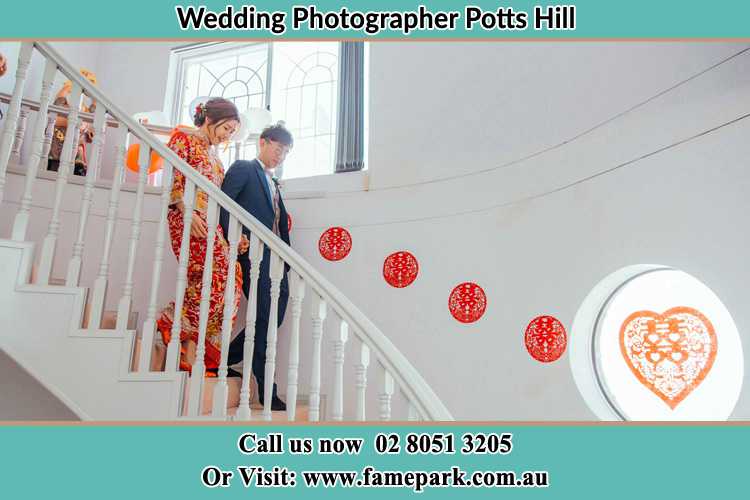 Photo of the Bride and the Groom going down the stair Potts Hill NSW 2143