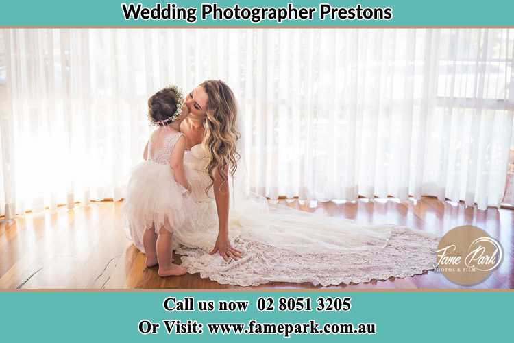 Photo of the Bride kiss the flower girl Prestons NSW 2170