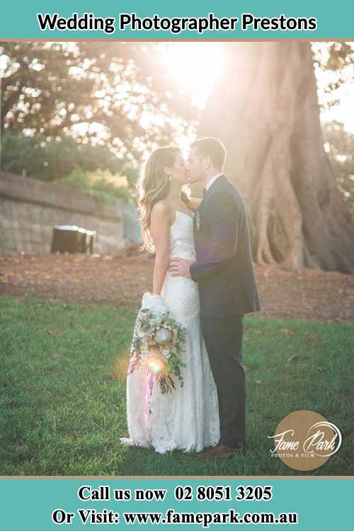 Photo of the Bride and the Groom kissing at the yard Prestons NSW 2170