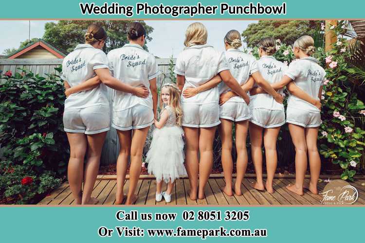 Behind photo of the Bride and the bridesmaids with the flower girl looking back Punchbowl NSW 2196