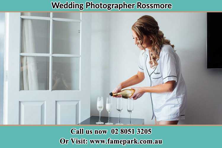 Photo of the Bride pouring wine to the glasses Rossmore NSW 2557