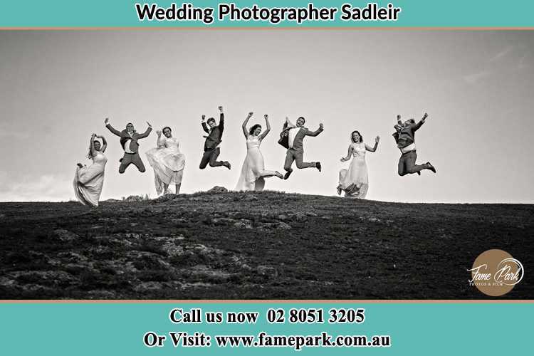 Jump shot photo of the Groom and the Bride with the entourage Sadleir NSW 2168