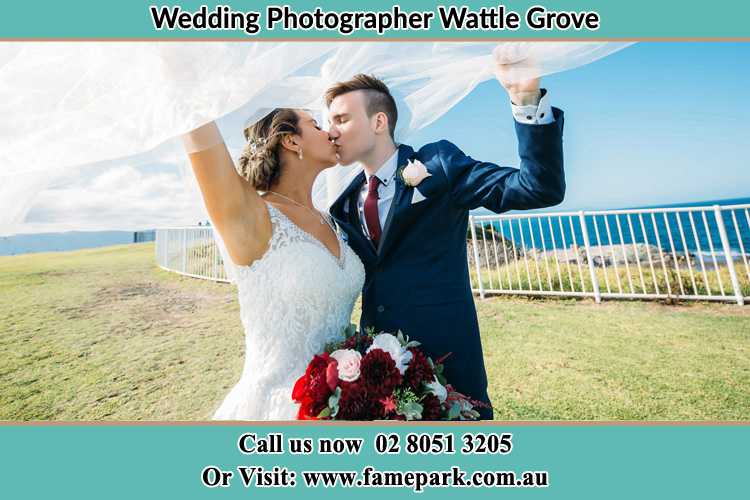 Photo of the Bride and the Groom kissing at the yard Wattle Grove NSW 2713