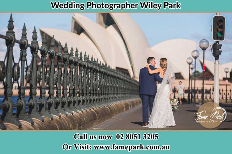 The Groom and the Bride walking towards the Sydney Grand Opera House Wiley Park NSW 2195